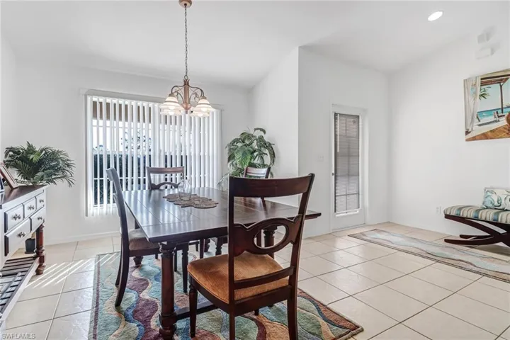 Tiled dining space with a chandelier