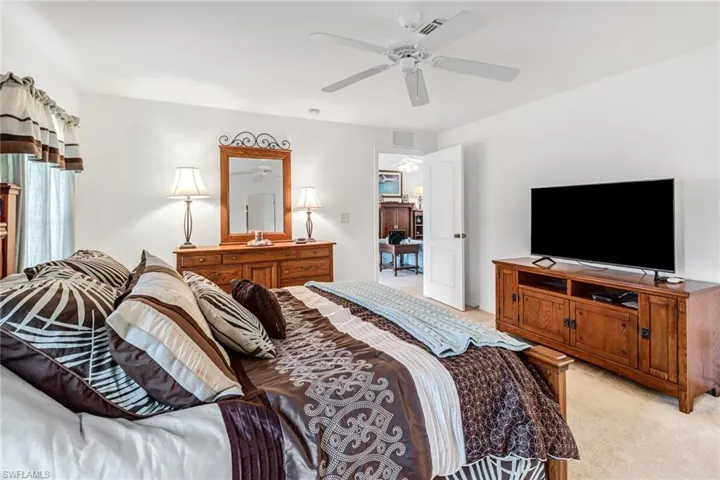 Carpeted bedroom with ceiling fan
