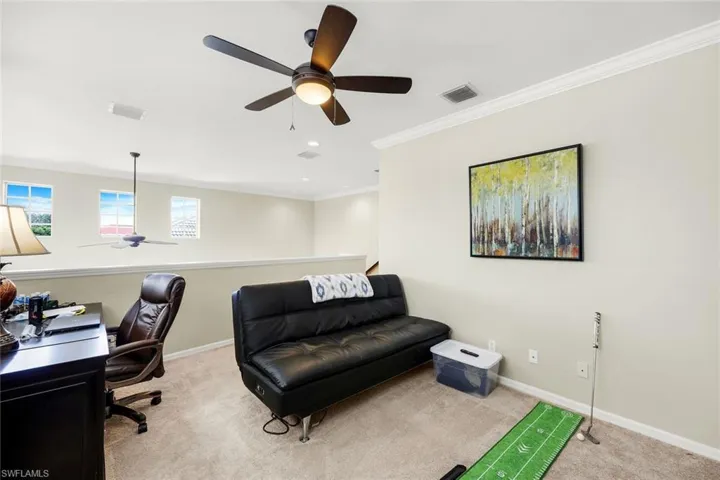 Office featuring a ceiling fan, light carpet, and ornamental molding