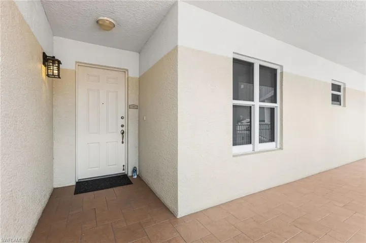 A charming breezeway leads to your front door, creating a graceful and welcoming transition into the home with an airy, inviting sense of arrival.