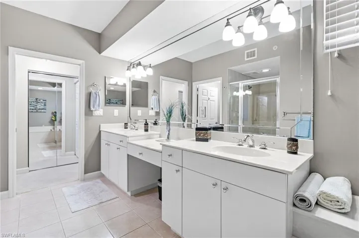 our primary bathroom is thoughtfully designed as a spa-inspired retreat, featuring elegant dual vanities, a dedicated dressing area, and a private water closet. This refined layout blends comfort and functionality, creating a serene space tailored for everyday luxury and ease.