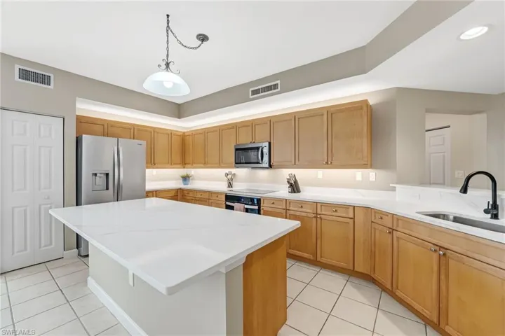 The sellers have recently elevated the kitchen with newly installed quartz countertops and a beautifully redesigned island—perfect for gathering with guests while the chef prepares meals. Enhanced with under- and over-cabinet lighting, brand-new stainless steel appliances, and a fresh, refined repaint throughout, the space exudes a bright, modern sophistication, creating a truly inviting and refreshed culinary environment.