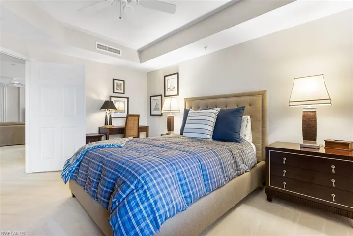 The den is currently utilized as a third bedroom, yet offers exceptional versatility with an effortless transition back to a refined office, private TV room, or intimate den. Elevated by a graceful tray ceiling and elegant double French doors, the space is designed to provide both privacy and sophistication, allowing it to adapt seamlessly to your lifestyle while maintaining a polished, upscale ambiance. Conveniently located just outside the door, the full third bathroom enhances functionality and ease for