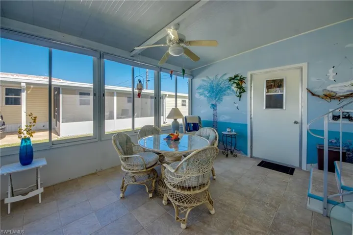 Sunroom featuring a wealth of natural light and ceiling fan