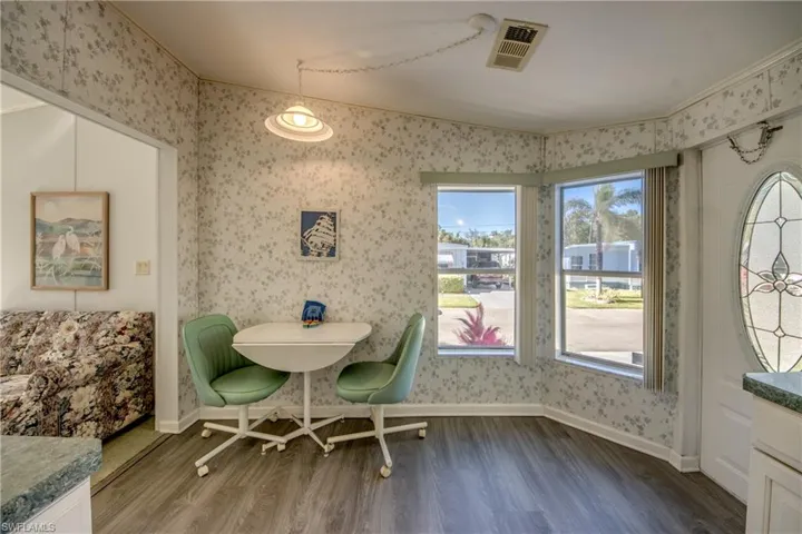 Dining space with crown molding and hardwood / wood-style floors