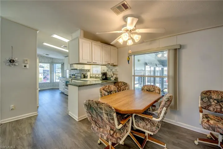 Dining space featuring dark hardwood / wood-style flooring, ceiling fan, and sink