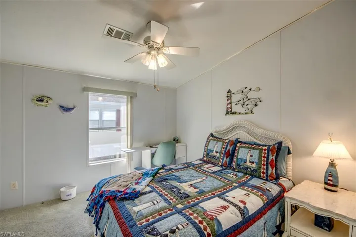 Bedroom featuring carpet, ceiling fan, and ornamental molding