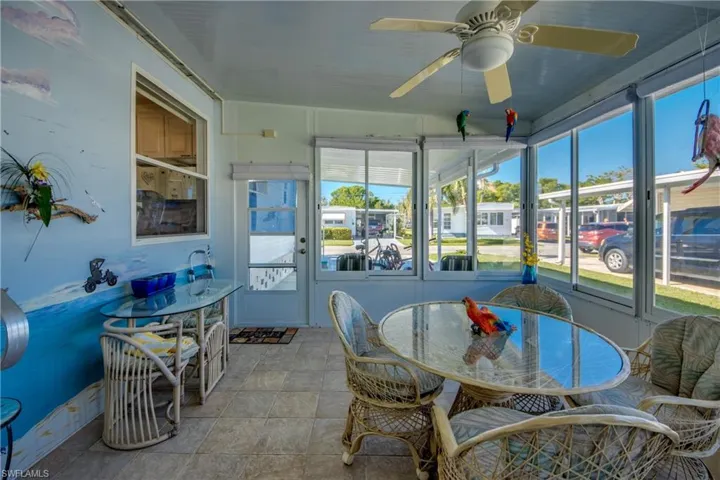 Sunroom / solarium with ceiling fan and a healthy amount of sunlight
