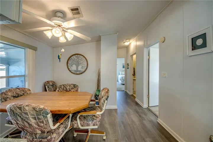Dining area featuring hardwood / wood-style flooring, ceiling fan, and ornamental molding