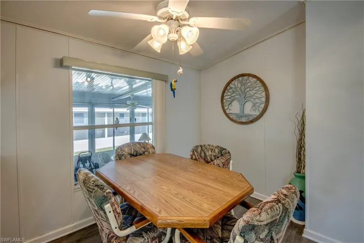 Dining area featuring dark hardwood / wood-style flooring, plenty of natural light, crown molding, and ceiling fan