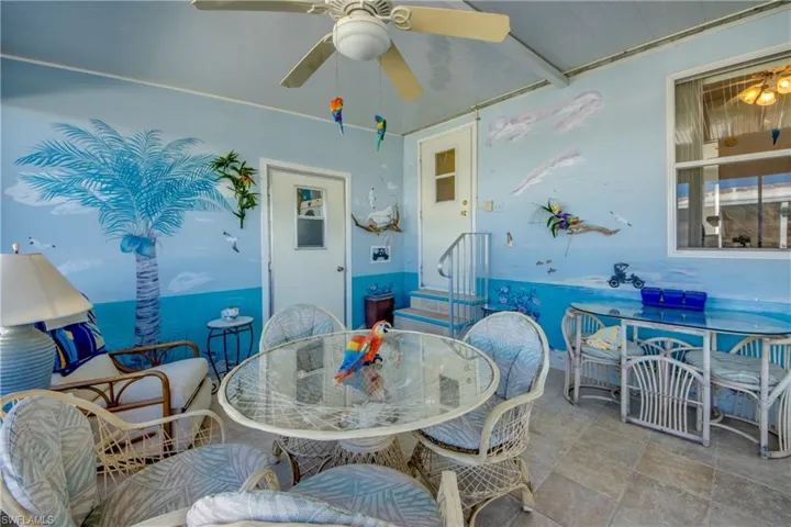 Dining area featuring ceiling fan and beamed ceiling