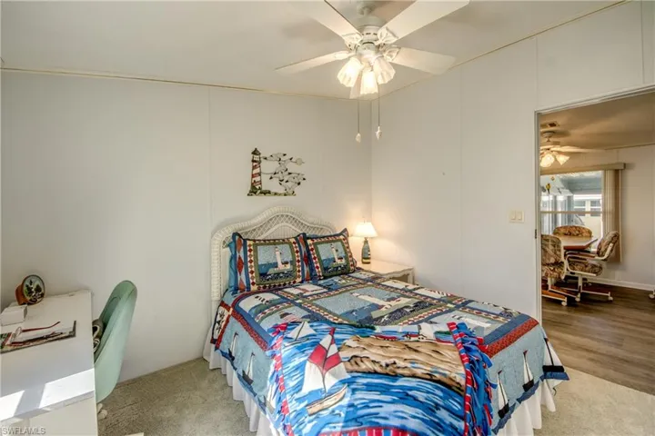Bedroom featuring ceiling fan and wood-type flooring