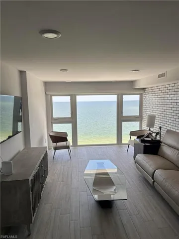 Living room featuring hardwood / wood-style floors and a water view