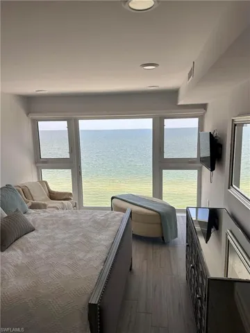 Bedroom with dark hardwood / wood-style flooring