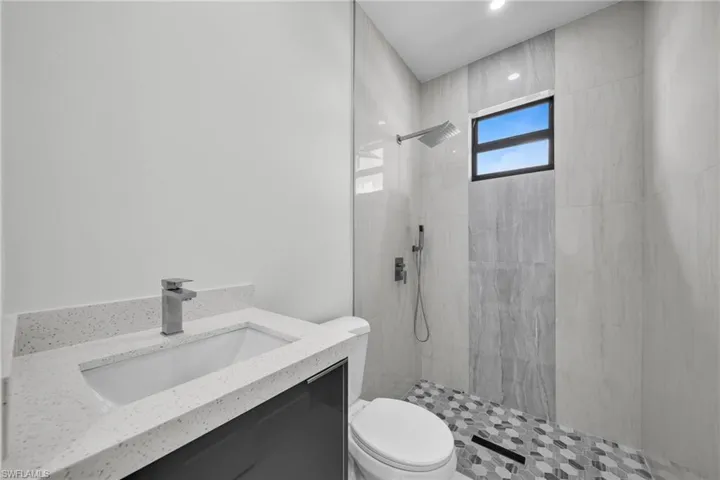Full bath with a tile shower and vanity