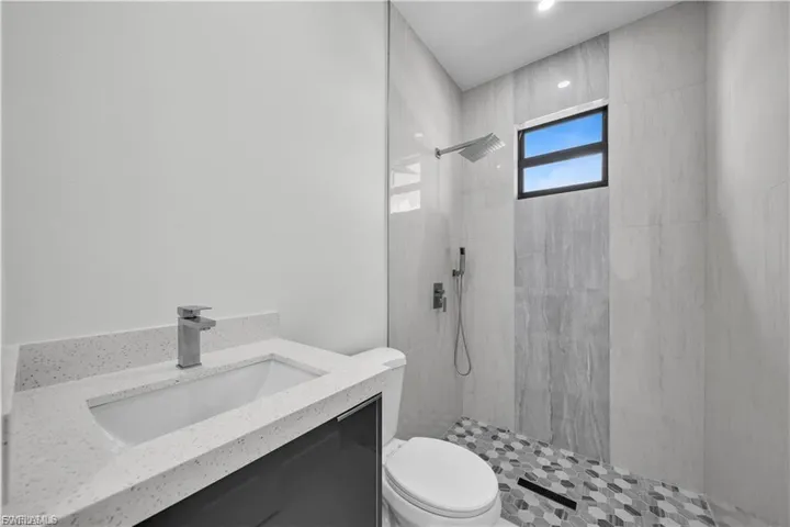 Bathroom with a tile shower and vanity