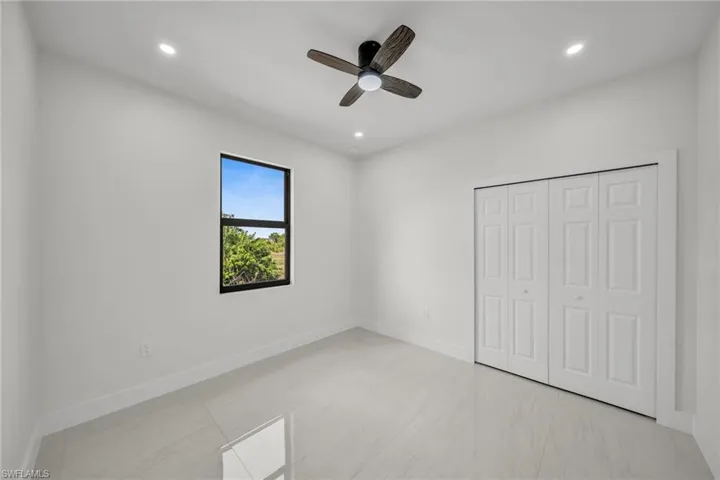 Unfurnished bedroom with recessed lighting, a ceiling fan, and a closet