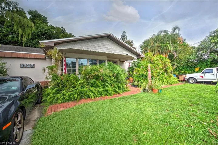 View of property exterior with a yard