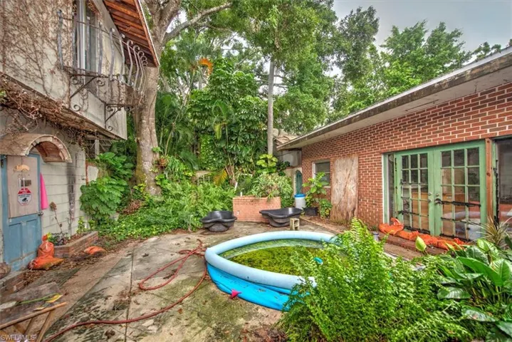 View of yard with french doors and a patio