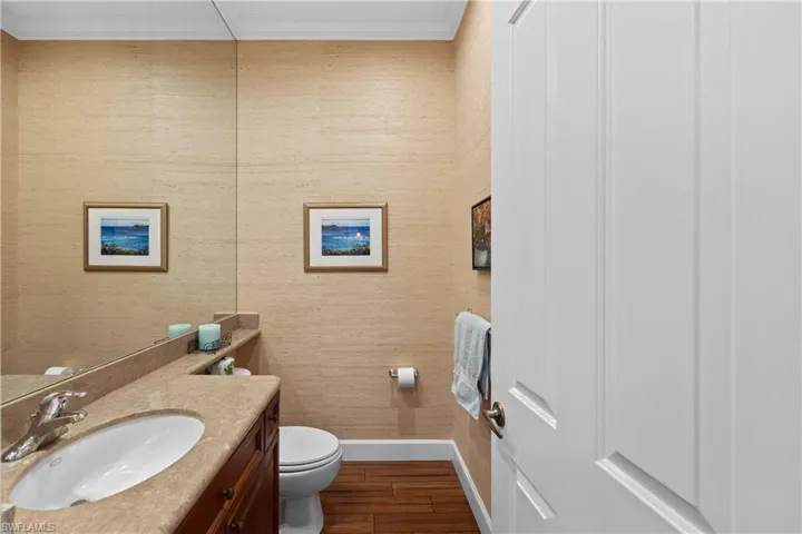 1/2 Bath with crown molding, vanity, and toilet