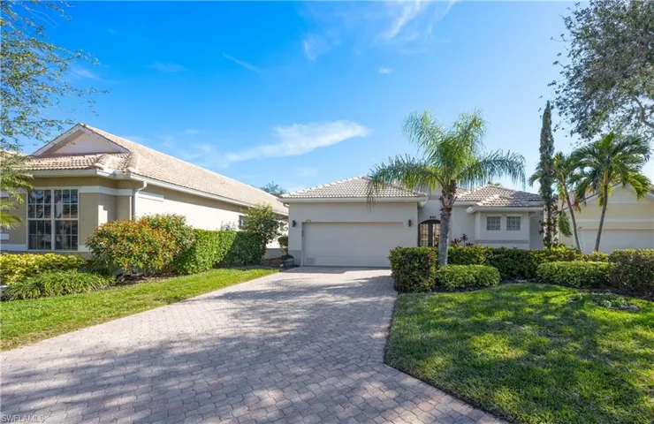 View of front of house featuring a garage and a front yard