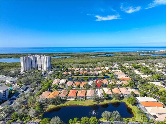 Birds eye view of property with a water view