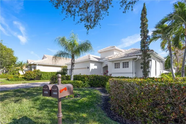 Mediterranean / spanish home with a garage and a front lawn