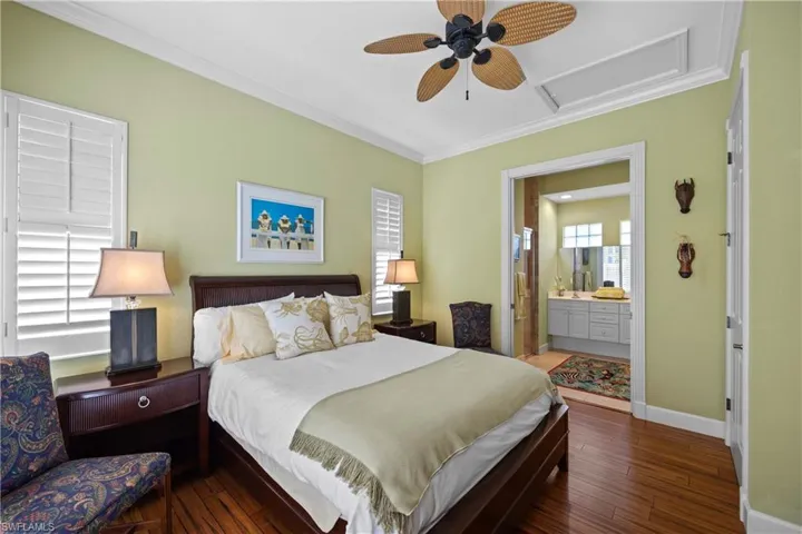 Cabana with dark hardwood / wood-style flooring, ensuite bath, ornamental molding, and ceiling fan