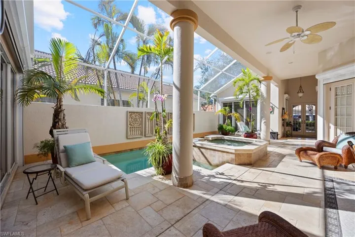 View of patio with french doors, ceiling fan, a swimming pool with hot tub, and a lanai