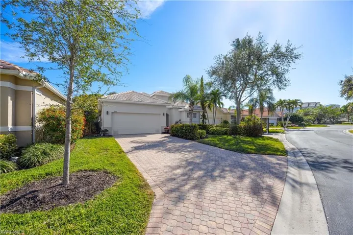 View of front of home featuring a garage and a front lawn