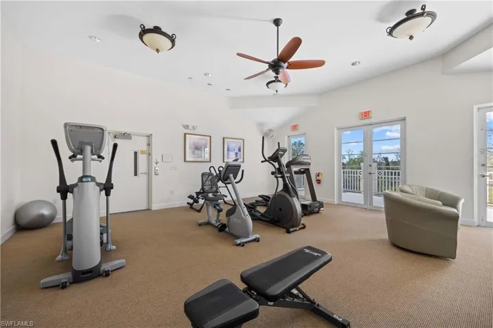 Workout area with french doors, ceiling fan, and lofted ceiling