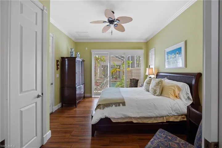Cabana with ceiling fan, ornamental molding, and dark hardwood / wood-style floors