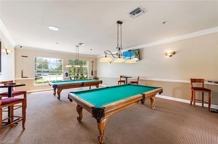 Game room featuring ornamental molding and pool table