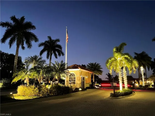 Property enrance at twilight featuring curved driveway