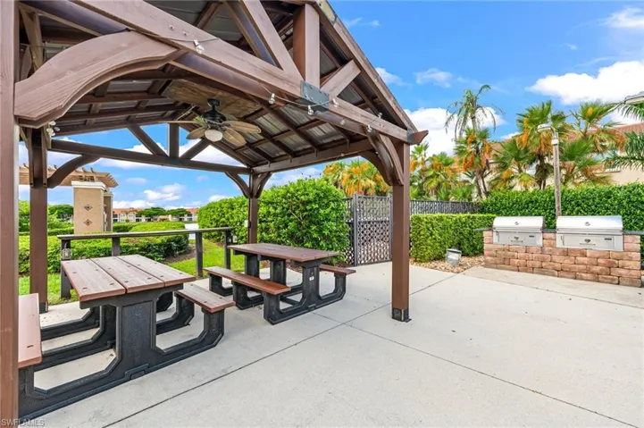 Surrounding community featuring a gazebo, an outdoor kitchen / dining area, and a patio