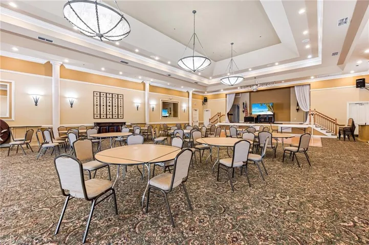 Dining space featuring carpet, ornamental molding, recessed lighting, and a tray ceiling