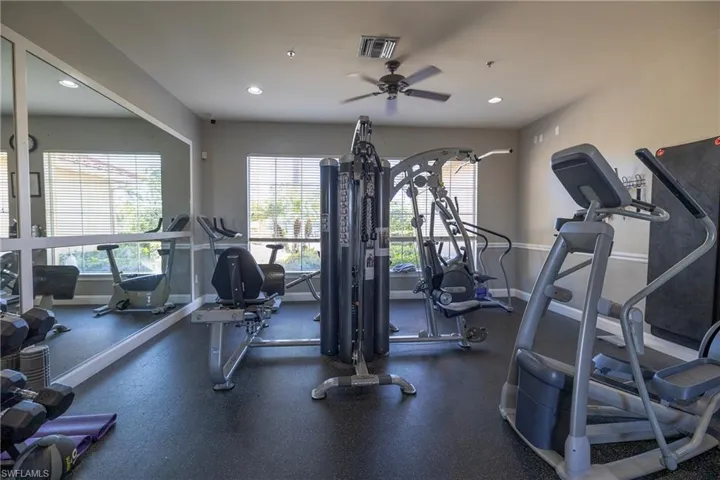 Workout area featuring a ceiling fan and recessed lighting