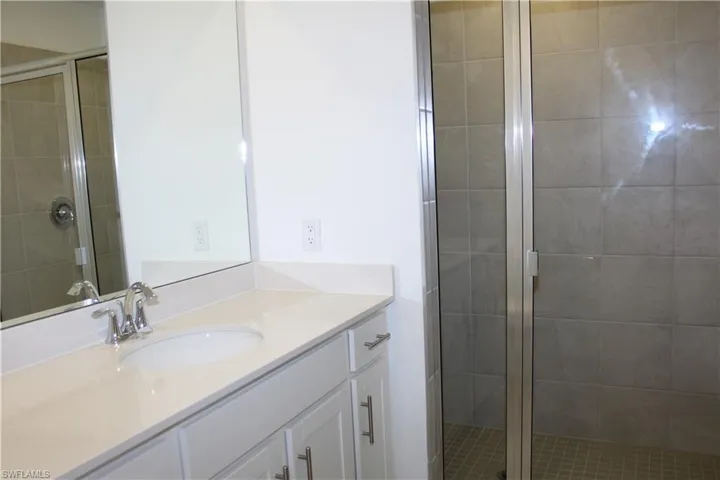 Master bath featuring vanity and a shower stall