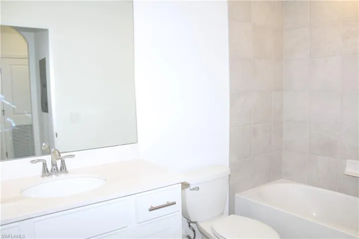 Guest Bathroom featuring vanity, toilet, and shower / tub combination