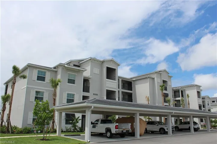 View of property with covered parking