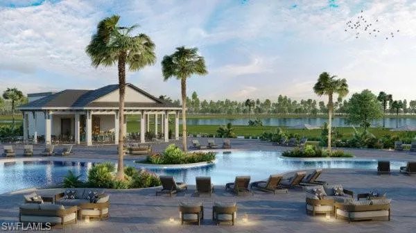 Community pool featuring a patio area, an outdoor structure, and a water view