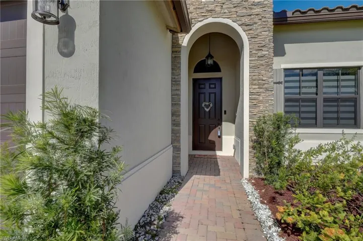 Gorgeous stacked stone accent and arched entryway