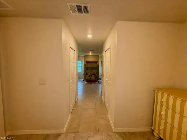Hallway featuring baseboards