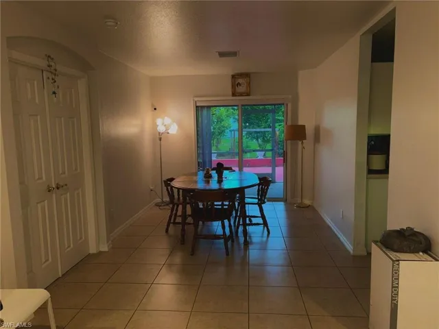 Dining room featuring light tile patterned floors and baseboards