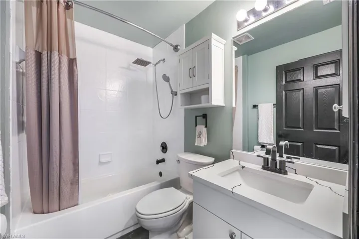 Bathroom featuring shower / bath combo and vanity