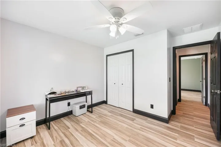 Bedroom featuring a closet, light wood-style floors, and a ceiling fan