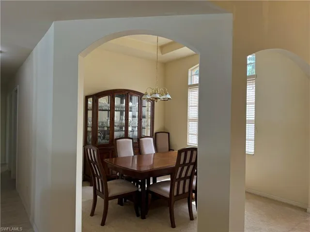 Dining space featuring a chandelier and a tray ceiling