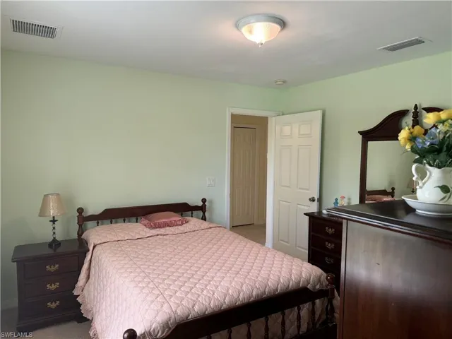 Bedroom featuring light colored carpet
