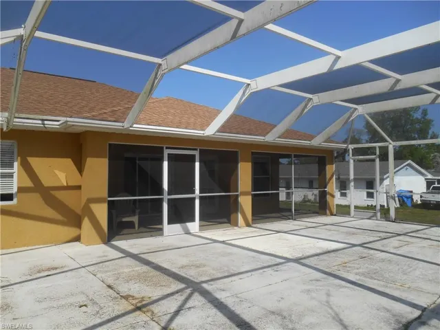 Rear view of house with a patio and a lanai