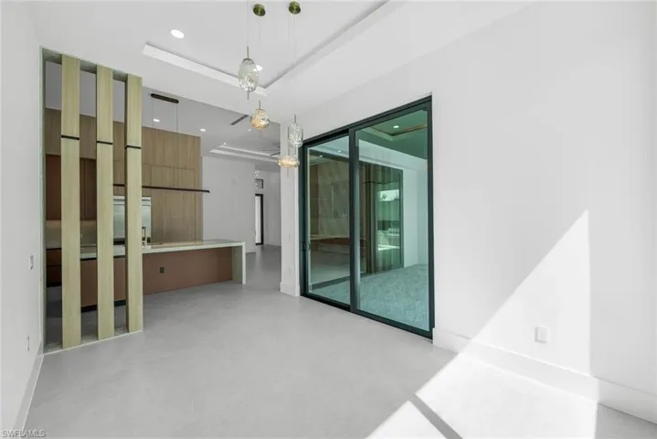 Empty room with recessed lighting, a raised ceiling, and concrete floors